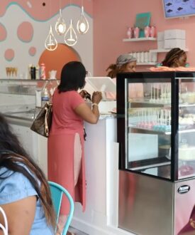 The bakery shop, customers at the counter and pastry case